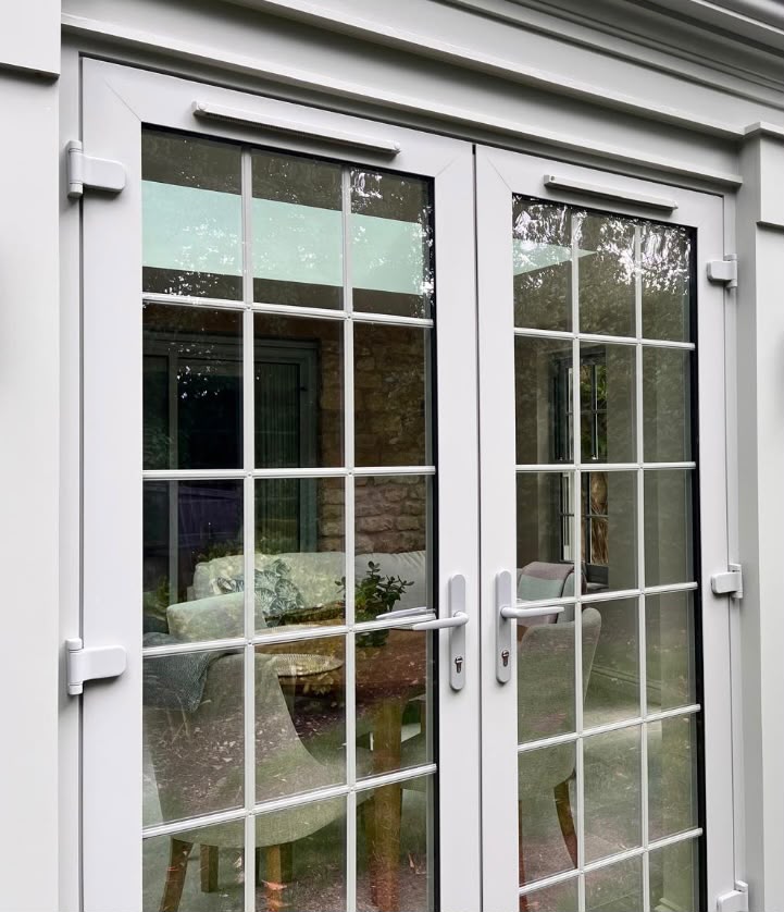 Close-up of grey French doors with Georgian bars